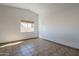 This bedroom features tile flooring, neutral walls, and a large window at 6841 W Yucca St, Peoria, AZ 85345