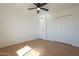 Neutral bedroom features hardwood floors, a ceiling fan, and a double door closet at 6841 W Yucca St, Peoria, AZ 85345