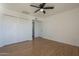 Inviting bedroom features laminate flooring, a ceiling fan, and a spacious double-door closet at 6841 W Yucca St, Peoria, AZ 85345