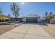 Single-story home with gray exterior, spacious driveway, and desert landscaping at 6841 W Yucca St, Peoria, AZ 85345