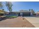 Charming single-story home featuring a low wall with decorative stone and a gravel yard at 6841 W Yucca St, Peoria, AZ 85345