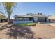 Charming single-story home featuring a low wall with decorative stone and a gravel yard at 6841 W Yucca St, Peoria, AZ 85345