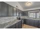 This kitchen includes black cabinets, stainless appliances, and a stone backsplash at 6841 W Yucca St, Peoria, AZ 85345