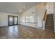 Spacious living room features tile flooring, high ceilings, and staircase to the upper level at 6841 W Yucca St, Peoria, AZ 85345