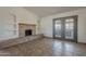 Living area featuring tile flooring, fireplace, and access to the backyard through glass doors at 6841 W Yucca St, Peoria, AZ 85345