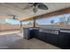 Covered outdoor kitchen with a large grill and abundant counter space for entertaining at 6841 W Yucca St, Peoria, AZ 85345