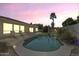 Backyard pool with clear water, lounge chairs, landscaping, and a beautiful sky at dusk at 7686 S Myrtle Ave, Tempe, AZ 85284