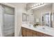 Bright bathroom featuring dual sinks, a large mirror, and a shower-tub combination at 7686 S Myrtle Ave, Tempe, AZ 85284