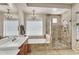 Elegant bathroom featuring a soaking tub, walk-in shower, double vanity and chandelier lighting at 7686 S Myrtle Ave, Tempe, AZ 85284