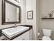 Clean powder room featuring a modern sink, toilet, and stylish decor at 7686 S Myrtle Ave, Tempe, AZ 85284