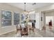 Dining area featuring an elegant chandelier, bright windows, and built-in cabinets at 7686 S Myrtle Ave, Tempe, AZ 85284