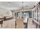 Elegant dining room with a chandelier, travertine flooring, and a large window at 7686 S Myrtle Ave, Tempe, AZ 85284