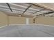 Spacious three car garage with a clean interior, lighting, and ample parking space at 7686 S Myrtle Ave, Tempe, AZ 85284