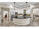 Kitchen showcasing white cabinets, stainless steel appliances, and a curved black countertop island at 7686 S Myrtle Ave, Tempe, AZ 85284