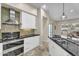 Modern kitchen featuring white cabinets, stainless steel appliances, and black countertops at 7686 S Myrtle Ave, Tempe, AZ 85284