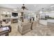 Open-concept living room with a fireplace, a ceiling fan and adjacent kitchen with modern countertops at 7686 S Myrtle Ave, Tempe, AZ 85284