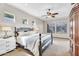 Main bedroom featuring bright windows, a ceiling fan, and neutral decor with a king-size bed at 7686 S Myrtle Ave, Tempe, AZ 85284