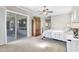 Bedroom with a sliding glass door access to the backyard, a ceiling fan, and neutral decor at 7686 S Myrtle Ave, Tempe, AZ 85284