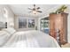 Main bedroom with bright windows overlooking the backyard, a ceiling fan, and neutral decor at 7686 S Myrtle Ave, Tempe, AZ 85284