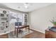 Well-lit home office with built-in bookshelves, a desk, and hardwood floors at 7686 S Myrtle Ave, Tempe, AZ 85284