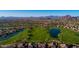 Gorgeous aerial view of a golf course community with mountain views and lush green landscaping at 7703 E Sayan St, Mesa, AZ 85207