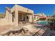 Inviting backyard showcasing a covered patio and sparkling pool surrounded by desert plants at 7703 E Sayan St, Mesa, AZ 85207