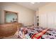 Comfortable bedroom featuring a wooden dresser, Southwest-themed bedding, and closet at 7703 E Sayan St, Mesa, AZ 85207