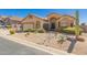 Charming single-story home with desert landscaping and a well-manicured lawn, complemented by a two-car garage at 7703 E Sayan St, Mesa, AZ 85207