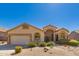 Charming single-story home featuring desert landscaping, attached two-car garage, and a welcoming front entrance at 7703 E Sayan St, Mesa, AZ 85207