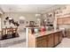 Open-concept kitchen with granite countertops, wooden cabinets, and a view of the adjacent dining area at 7703 E Sayan St, Mesa, AZ 85207