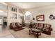 Cozy living room featuring comfortable seating, a decorative rug, and an adjacent dining space at 7703 E Sayan St, Mesa, AZ 85207