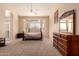 Comfortable main bedroom with large windows and a ceiling fan at 7703 E Sayan St, Mesa, AZ 85207