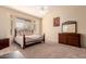 Sunlit main bedroom with carpet, and large windows at 7703 E Sayan St, Mesa, AZ 85207