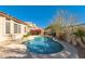 Private pool and patio with mature landscaping and a sunny sky above at 7703 E Sayan St, Mesa, AZ 85207