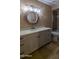 Bathroom featuring updated countertops, modern lighting, and updated travertine-style tile floor at 9196 E Evans Dr, Scottsdale, AZ 85260