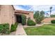 Charming front exterior of the home with lush landscaping, a tile roof, and inviting entrance at 9196 E Evans Dr, Scottsdale, AZ 85260