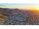 Breathtaking aerial view of a Primary-planned community nestled against stunning mountain views during a golden sunset at 9831 S 11Th St, Phoenix, AZ 85042