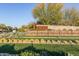 Community entrance with native landscaping, desert plants, and stone feature wall at 9831 S 11Th St, Phoenix, AZ 85042