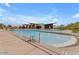 Resort-style community pool with lounge chairs, clubhouse, and desert landscaping at 9831 S 11Th St, Phoenix, AZ 85042