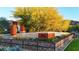 Community entrance with desert landscaping, monument signage, and decorative rock wall at 9831 S 11Th St, Phoenix, AZ 85042