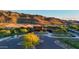 Front exterior of modern home, desert landscape and surrounding mountains at 9831 S 11Th St, Phoenix, AZ 85042