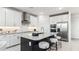 Contemporary kitchen featuring an island with stool seating, stainless steel appliances, and crisp white cabinets at 9831 S 11Th St, Phoenix, AZ 85042