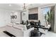 Bright and airy living room features modern decor, large windows, and a stylish entertainment center at 9831 S 11Th St, Phoenix, AZ 85042