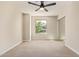 A bright bedroom featuring a ceiling fan, natural light, and a mirrored closet at 10422 N 11Th Pl # 3, Phoenix, AZ 85020