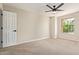 Spacious bedroom with neutral carpet, a ceiling fan, and a sunlit window at 10422 N 11Th Pl # 3, Phoenix, AZ 85020