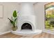 Unique living room fireplace with decorative white finish and hardwood floors at 10422 N 11Th Pl # 3, Phoenix, AZ 85020