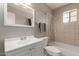 Well-lit bathroom with shower-tub combo and neutral colored tiles at 113 N Ridge Cir, Mesa, AZ 85203