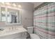 Bathroom featuring a toilet, shower with colorful curtain and a sink and mirror at 113 N Ridge Cir, Mesa, AZ 85203