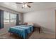 Serene bedroom with plush carpet, ceiling fan, and natural light from the window at 113 N Ridge Cir, Mesa, AZ 85203