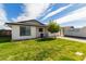 Attractive single-Gathering home featuring a green lawn and a paved driveway on a sunny day at 113 N Ridge Cir, Mesa, AZ 85203